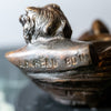 Small bronze baby in basket