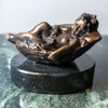 Small bronze baby in basket