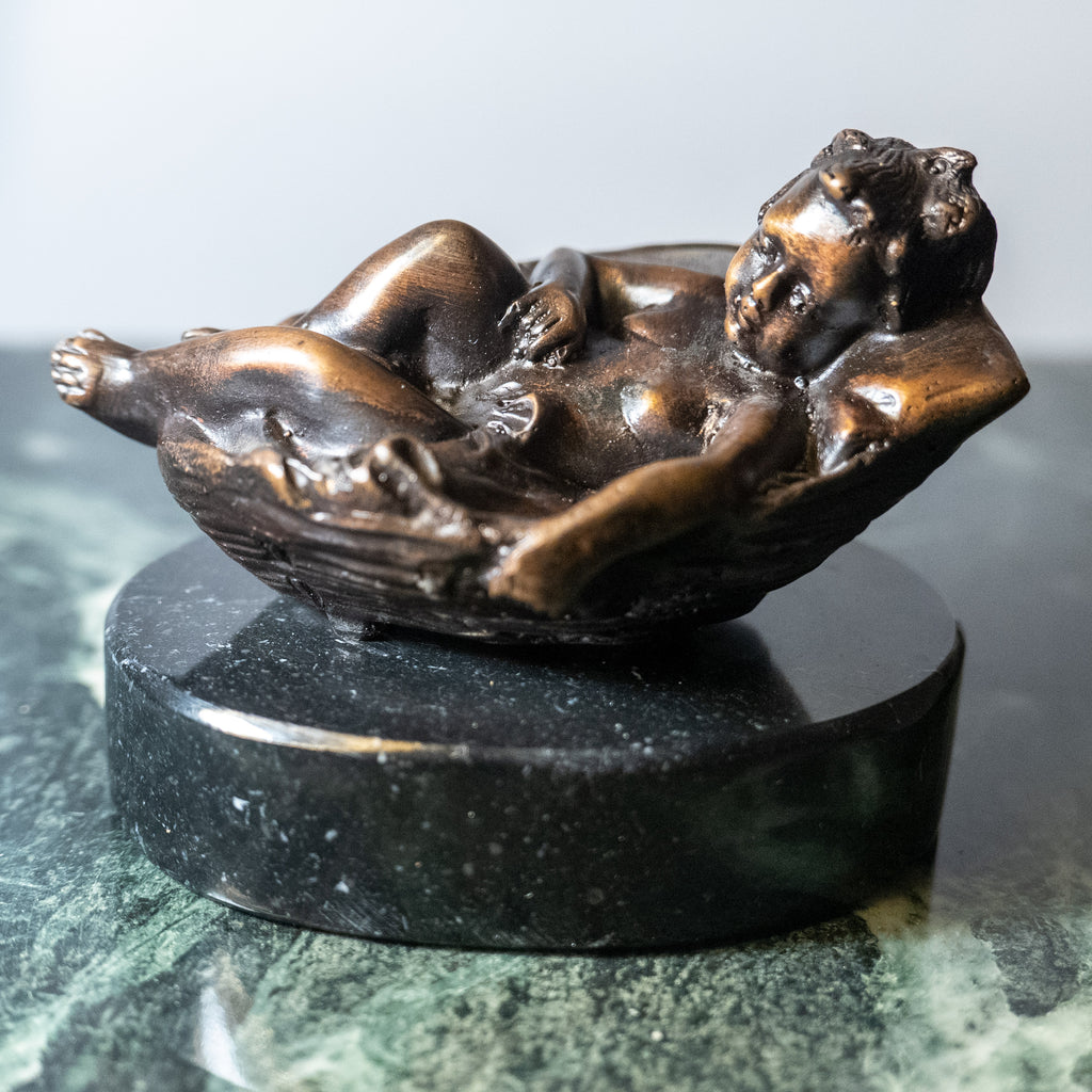 Small bronze baby in basket