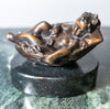 Small bronze baby in basket