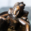 Small bronze baby in basket