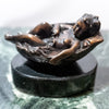Small bronze baby in basket