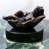 Small bronze baby in basket